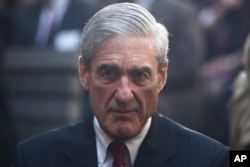 FILE - Former FBI Director Robert Mueller is seated before President Barack Obama and FBI Director James Comey arrive at an installation ceremony at FBI Headquarters in Washington, Oct. 28, 2013.