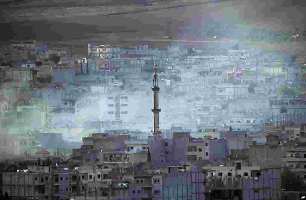 Smoke rises following a strike in Kobani, Syria while fighting continues between Syrian Kurds and the&nbsp; Islamic State militants near the Turkey-Syria border, Oct. 15, 2014. 