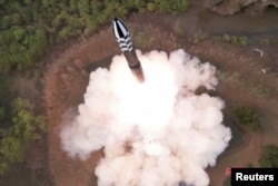 A view of a test launch of a new solid-fuel intercontinental ballistic missile (ICBM) Hwasong-18 at an undisclosed location in this still image of a photo used in a video released by North Korea's Korean Central News Agency (KCNA), April 14, 2023.