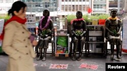 Statues of "comfort women" are placed outside Japan's consulate to commemorate the 80th anniversary of the Nanjing Massacre, in Hong Kong, China, Dec. 13, 2017. 