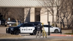 An FBI agent processes the scene in front of the Congregation Beth Israel synagogue, Jan. 16, 2022, in Colleyville, Texas, where a man held hostages for more than 10 hours Saturday.
