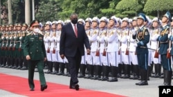 U.S. Secretary of Defense Lloyd Austin with Vietnamese Defense Minister Phan Van Giang, left, inspects an honor guard in Hanoi, Vietnam, Thursday, July 29, 2021. 