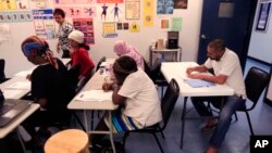 FILE - Refugees attend English class at Della Lamb Community Services in Kansas City, Mo., on June 13, 2016.