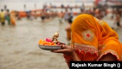 Seorang penganut Hindu berdoa kepada Dewa Matahari setelah berenang di Sangam, pertemuan sungai Gangga, Yamuna dan sungai Saraswati daiam festival Maha Shivratri di Prayagraj, India, 21 Februari 2020. (AP Photo/Rajesh Kumar Singh)
