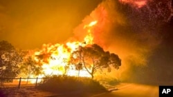 A fire rages in bushland near the West Australian city of Wannaroo, north of Perth in the early hours of Nov. 23, 2023. 