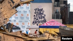 FILE - Workers clean up the site of the Historic Karnofsky Shop, that collapsed during Hurricane Ida in New Orleans, Louisiana, Sept. 6, 2021.