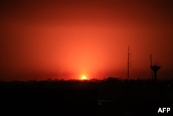 An Israeli strike lights the sky above Khan Yunis in the southern Gaza Strip as battles resumed between Israel and Hamas militants on Dec. 2, 2023.