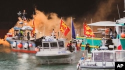 FILE - Fishing vessels at sea off the coast of Jersey, May 6, 2021. This week France rallied EU partners for a joint stance and action if London won't grant more licenses for small French fishing boats to roam close to the U.K.