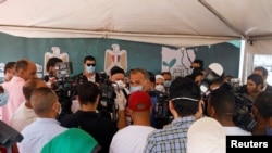 FILE - Journalists listen to Egypt's Minister of Social Solidarity Nevin el-Qabbaj at the Egyptian Food Bank, Cairo, May 2, 2020. Under President Abdel-Fattah el-Sissi, prosecutors have frequently brought vague charges against journalists and activists.