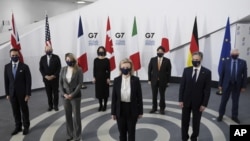 7 foreign ministers, pose in a socially distanced manner for a group photo at the Museum of Liverpool, Liverpool, England, Saturday Dec. 11, 2021. Foreign Secretary Liz Truss is hosting U.S. Secretary of State Antony Blinken and other Group of Seven count