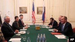 U.S. Secretary of State Rex Tillerson, left, speaks with his Russian counterpart Sergey Lavrov at the OSCE Foreign Ministers meeting in Vienna, Austria, Dec. 7, 2017.