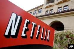 FILE - A sign points to Netfilx headquarters in Los Gatos, California