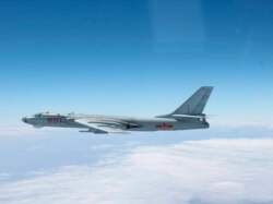 A Chinese military plane H-6 bomber flies through airspace between Okinawa prefecture's main island and the smaller Miyako island in southern Japan, photo taken Oct. 27, 2013.