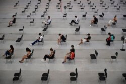 FILE - People wait 15 minutes after receiving the Pfizer COVID-19 vaccine during national COVID-19 vaccination campaign in Pamplona, northern Spain, Sept. 2, 2021.