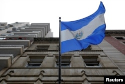 FILE - The El Salvador national flag hangs outside the Consulate General of El Salvador in Manhattan, New York, Jan. 8, 2018.