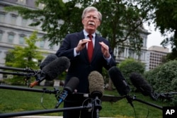 FILE - White House national security adviser John Bolton talks to reporters about Venezuela, in Washington, May 1, 2019.