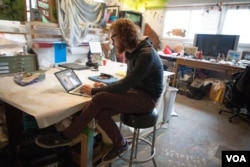 Artist in residence at Union Arts D.C. Graham Boyle is part of Passions and Flags Collective and Art Under Pressure, two artist organizations that have provided pro bono artwork for community social justice campaigns, April 3, 2016. (A. Hernandez/VOA)