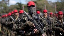 FILE - Soldiers who will be deployed during the Olympic games are presented during a ceremony in Rio de Janeiro, Brazil, July 8, 2016. 