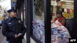 Officer L.A. Sanchez walks a beat in a downtown shopping area in Camden, New Jersey, in November 2010. "The Camden Police Department will not abandon its community policing philosophy," said Chief Scott Thomson, even as the department and other city agenc