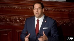 FILE - Tunisian Prime Minister Youssef Chahed speaks to the parliament in Tunis, Nov. 21, 2017.