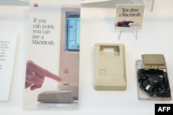 Forty years after igniting a PC revolution, Apple's Mac is stronger than ever and could reach new glory due to AI computing - or be left behind. (Photo by Loren Elliott / AFP)