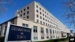 File - The Harry S. Truman Building, headquarters for the State Department, is seen in Washington, in this March 9, 2009 file photo. A retired State Department worker, Walter Kendall Myers and his wife Gwendolyn Steingraber Myers, have been…