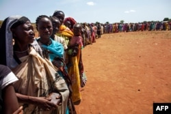 FILE - People displaced by conflict wait to be registered by the International Organization for Migration and the World Food Program, in Wau, South Sudan, May 11, 2016.