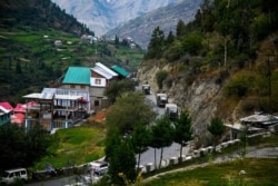 In this Sept. 3, 2020, picture, an Indian Army convoy makes way along a highway in Kyelang, some 120 kilometers from the Indo-Tibetan border.