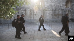 Israeli police officers walk outside the Al Aqsa Mosque compound in Jerusalem's Old City, July 25, 2017. 