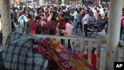 Indian daily wage laborers wait to get hired in Mumbai, India, Feb 1, 2020.