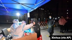 天津医护人员给市民进行新冠病毒核酸检测。（2022年1月12日）