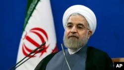Iran's President Hassan Rouhani, speaking in Tehran on the second anniversary of his election, vowed that his nation wouldn't allow state secrets to be jeopardized under the cover of nuclear inspections, June 13, 2015. 