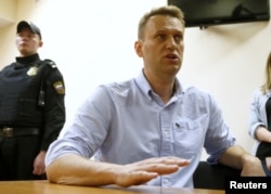 Russian opposition leader Alexei Navalny talks to journalists during a hearing at a court in Moscow, Russia, June 12, 2017.