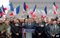 FILE - French conservative presidential candidate Francois Fillon delivers his speech during a rally in Paris, March 5, 2017.
