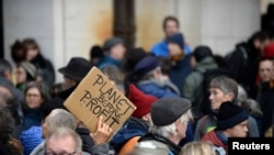 People attend a climate change protest in Brussels, Belgium, Dec. 8, 2019. 