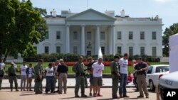 Demonstrators are arrested outside White House during protest on immigration reform, Washington, Aug. 28, 2014.