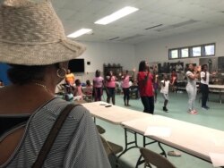 Baltimore City’s Liberty Village Project Manager Kim Trueheart looks on as her summer programs keep children active. Trueheart says “Charm City” needs jobs. (VOA/C. Presutti)