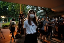 FILE - Pro-democracy activist Agnes Chow speaks to the media after reporting to police to extend her bail in Hong Kong, Sept. 1, 2020. Chow was arrested Aug. 10 under Hong Kong's National Security Law, for allegedly inciting secession, she said.