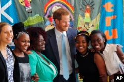 Britain's Prince Harry was among other famous people who spoke at the conference, 2016. He is pictured with young AIDS Ambassadors. (AP Photo)