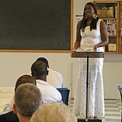 Scholarship winner Tomi Dare speaks to inmates