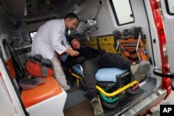 A Nepalese doctor conducts a routine medical check on Chinese climber Liu Lei after he successfully summited Mount Everest upon his arrival at the airport in Kathmandu, Nepal, May 24, 2016.