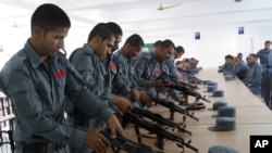 FILE - Afghan security forces practice handling their weapons in Lashkargah, Helmand province, July 23, 2016.