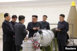 North Korean leader Kim Jong Un, center, provides guidance on nuclear weapons development in this undated photo released by North Korea's Korean Central News Agency in Pyongyang, Sept. 3, 2017.
