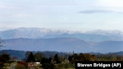 The Great Smoky Mountains rise in the background about 20 miles away from this Knoxville, Tenn., neighborhood on Thursday, March 10, 2005.