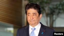 Japan's Prime Minister Shinzo Abe arrives at his official residence in Tokyo, Japan, in this photo taken by Kyodo, May 14, 2017, after South Korea's military said that North Korean had fired an unidentified projectile from a region near its west coast.