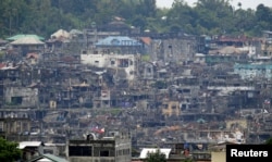 Damaged houses and buildings are seen as the government troops continue their assault against the pro-Islamic State militant group during a clearing operation in Marawi city, southern Philippines, Oct. 18, 2017.