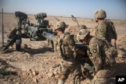 FILE - U.S. soldiers ready a howitzer to be towed into position at Bost Airfield in Afghanistan's Helmand Province in this June 10, 2017, photo provided by Operation Resolute Support. During the presidential campaign, Donald Trump argued for a complete withdrawal of U.S. troops from Afghanistan. In recent weeks, Trump boosted the number of American troops there.