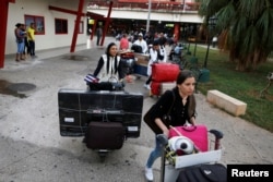 Cuban doctors leave the Jose Marti International Airport after arriving from Brazil, in Havana, Cuba, Nov. 23, 2018.