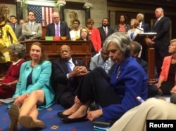 A photo shot and tweeted from the floor of the U.S. House of Representatives by Rep. Katherine Clark shows Democratic members of the House staging a sit-in on the House floor "to demand action on common sense gun legislation" on Capitol Hill in Washington.