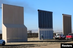 Three of President Donald Trump's eight border wall prototypes are shown near completion along U.S.- Mexico border in San Diego, California, Oct. 23, 2017.